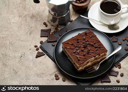 Portion of Traditional Italian Tiramisu dessert and mocha coffee maker on grey concrete background.. Portion of Traditional Italian Tiramisu dessert and mocha coffee maker on grey concrete background