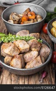 portion roast pork meat. Stew meat.Pieces of fried pork steak meat in a stylish dish.