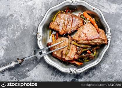 Portions of grilled fillet steak with roast vegetables.Grilled meat. Beef with vegetables