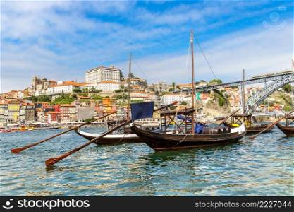 Porto and old  traditional boats with wine barrels in Portugal in a summer day