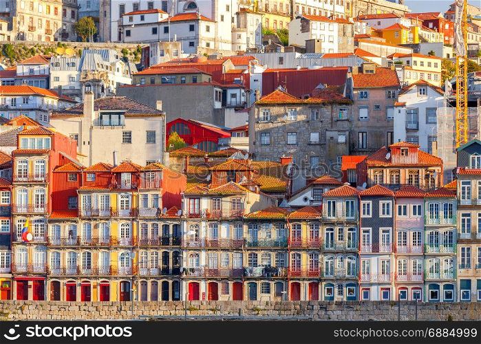 Porto. Multicolored houses on the waterfront of the Douro River.. View of old medieval colorful houses along the Douro River embankment. Porto. Portugal.