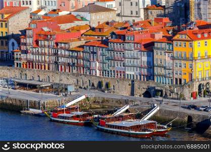 Porto. Multicolored houses on the waterfront of the Douro River.. View of old medieval colorful houses along the Douro River embankment. Porto. Portugal.