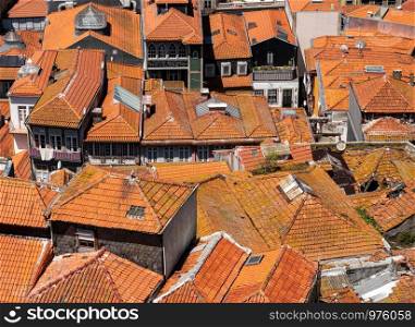 Porto, Portugal - 12 August 2019: View over the roofs from the top of the Cathedral tower in Oporto. View over the red roofs of homes from the tower of Cathedral in Porto