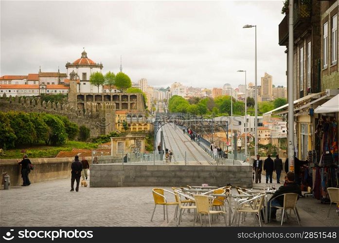 PORTO, PORTUGAL - APRIL 21, 2012 - View towards Don Luis I bridge with metro line and Serra do Pilar monastey behind. Bridge is one of many attractions in Porto, from where you can get magnificent view