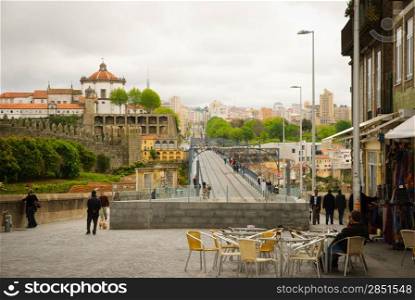 PORTO, PORTUGAL - APRIL 21, 2012 - View towards Don Luis I bridge with metro line and Serra do Pilar monastey behind. Bridge is one of many attractions in Porto, from where you can get magnificent view