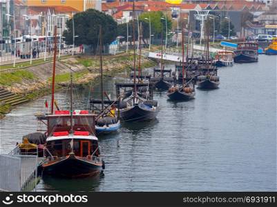 Porto. Traditional boats for wine transportation.. A view of the Ribeira embankment and old boats with barrels for wine. Porto. Portugal.