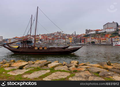 Porto. Traditional boats for wine transportation.. A view of the Ribeira embankment and old boats with barrels for wine. Porto. Portugal.