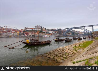 Porto. Traditional boats for wine transportation.. A view of the Ribeira embankment and old boats with barrels for wine. Porto. Portugal.