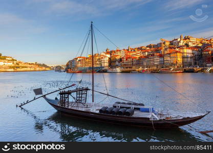 Porto. Traditional boats for wine transportation.. A view of the Ribeira embankment and old boats with barrels for wine. Porto. Portugal.