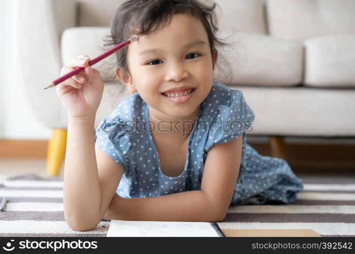 portrait a little cute girl is studying the new lesson, smile, cheerful