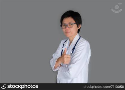 Portrait-A mature Doctor with stethoscope looking at Camera on gray background.