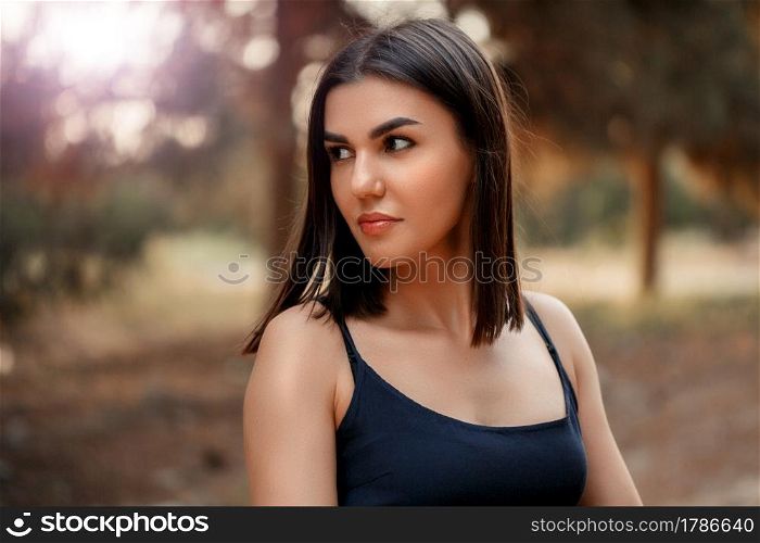 portrait.a young brunette woman of Asian appearance in a blue dress. there is a grain and a small depth of focus in the photo for artistic purposes.. portrait.a young brunette woman of Asian appearance in a blue dress. there is a grain and a small depth of focus in the photo for artistic purposes
