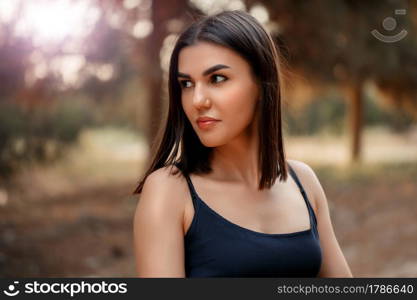 portrait.a young brunette woman of Asian appearance in a blue dress. there is a grain and a small depth of focus in the photo for artistic purposes.. portrait.a young brunette woman of Asian appearance in a blue dress. there is a grain and a small depth of focus in the photo for artistic purposes