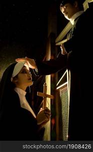 Portrait and rim light of nun and priest in dark night. Halloween and Religion concept.