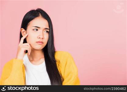 Portrait Asian beautiful young woman standing chin handle relaxed thinking about something about the question studio shot isolated on pink background, Thai female idea think with copy space