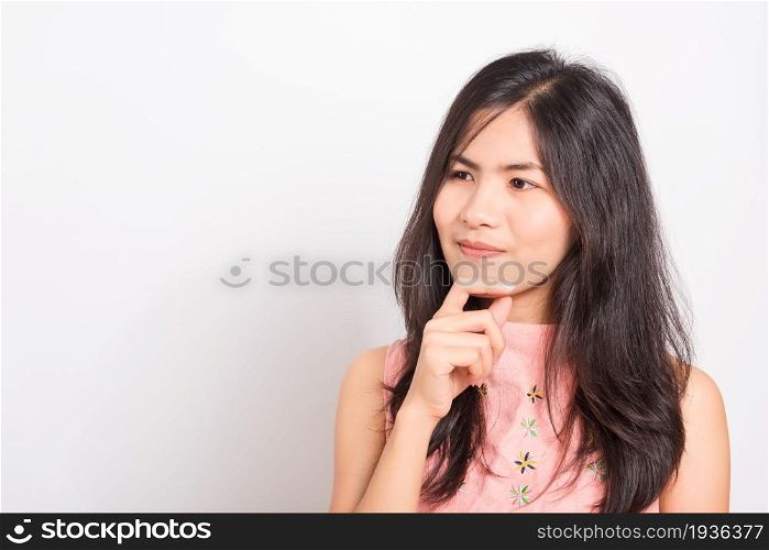 Portrait Asian beautiful young woman standing, She thinking or dreaming and looking up above, shoot photo in studio on white background, There was copy space on the left hand side
