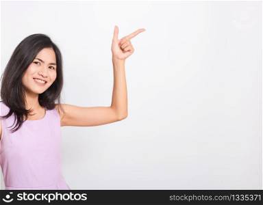 Portrait Asian beautiful young woman standing smile seeing white teeth, She pointing finger up and looking at camera, shoot photo in studio on white background. There was copy space to put text