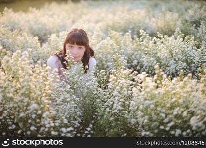 Portrait asian girl with little white flowers background