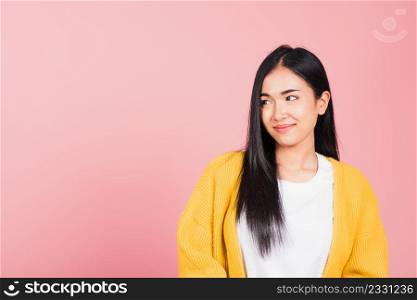 Portrait Asian lifestyle beautiful young woman standing smile looking side away, studio shot isolated on pink background, Happy face Thai female cute with copy space