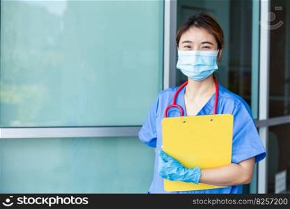 Portrait Asian nurse medical staff standing with face mask in hospital with space for text.