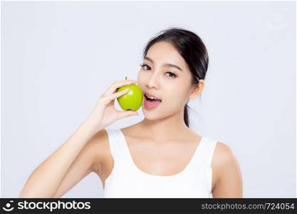 Portrait asian woman smiling holding and eating green apple fruit and beautiful body diet with fit isolated on white background, girl weight slim with cellulite or calories, health and wellness concept.