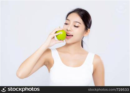 Portrait asian woman smiling holding and eating green apple fruit and beautiful body diet with fit isolated on white background, girl weight slim with cellulite or calories, health and wellness concept.