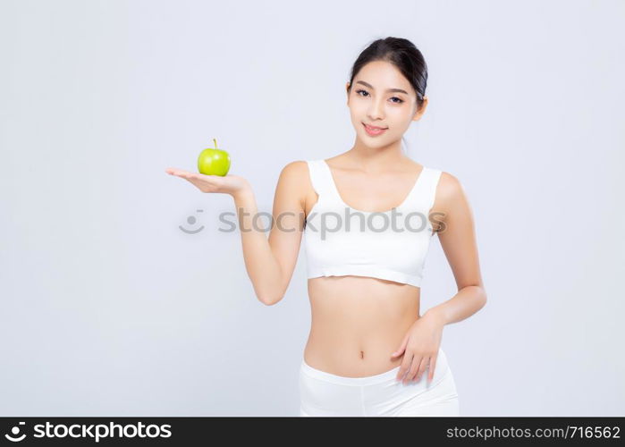 Portrait asian woman smiling holding green apple fruit and beautiful body diet with fit isolated on white background, girl weight slim with cellulite or calories, health and wellness concept.