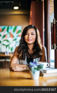 Portrait asian woman smiling relax in coffee shop cafe