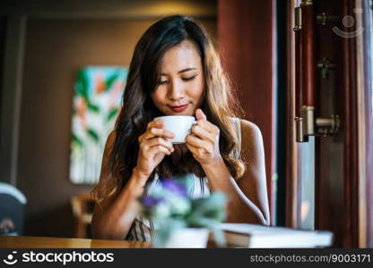 Portrait asian woman smiling relax in coffee shop cafe