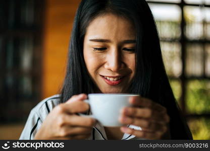 Portrait asian woman smiling relax in coffee shop cafe