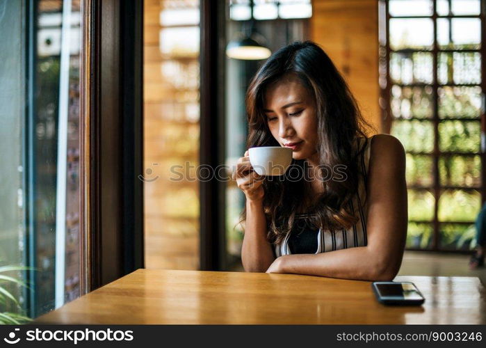 Portrait asian woman smiling relax in coffee shop cafe