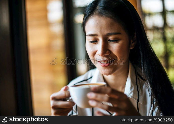 Portrait asian woman smiling relax in coffee shop cafe