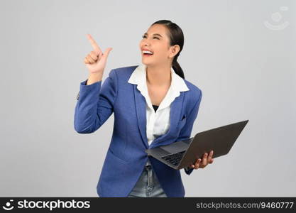Portrait Asian young woman in officer uniform point finger and hold laptop computer posture,  Pretty girl smiling with happy, isolated on white background