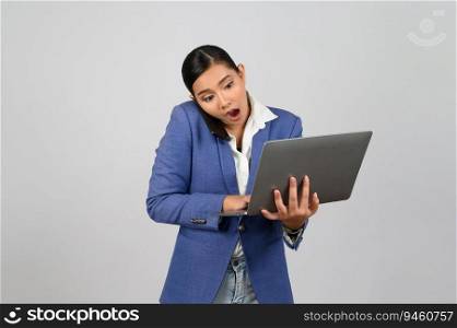 Portrait Asian young woman in officer uniform standing posture talking with mobile phone during working with laptop computer in hand with feel exciting,  isolated on white background
