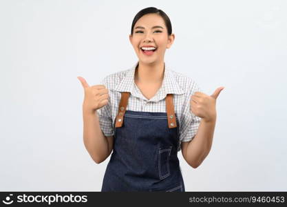 Portrait Asian young woman in waitress uniform and apron standing showing thumb up posture, Cheerful girl  happy smiling with hand signal for good, isolated on white background