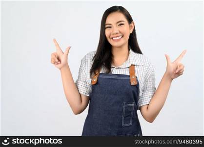 Portrait Asian young woman smile with happy in waitress uniform and apron, Cheerful girl standing with hand signal, point finger isolated on white background, copy space