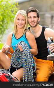 Portrait backpack active young couple sitting by terrace climbing gear