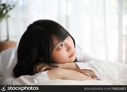 Portrait beautiful asian girl sleeping on bed in white room