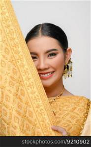 Portrait beautiful Asian woman in traditional Thai dress costume smile and pose with breast cloth cover her face with gracefully on white background