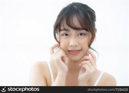 Portrait beautiful asian woman makeup of cosmetic, girl hand touch cheek and smile attractive, face beauty perfect with wellness in the bedroom at home with skin care and healthcare concept.