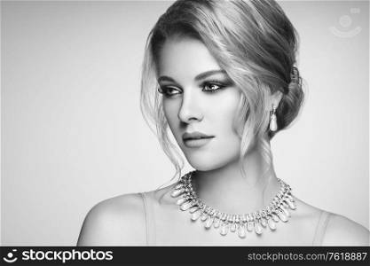 Portrait Beautiful Blonde Woman with Jewelry. Elegant Hairstyle. Beauty and Fashion Accessories. Perfect Make-Up. Black and White photo
