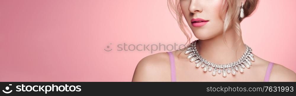 Portrait Beautiful Blonde Woman with Jewelry. Elegant Hairstyle. Beauty and Fashion Accessories. Perfect Make-Up. Pink Background