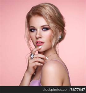 Portrait Beautiful Blonde Woman with Jewelry. Model Girl with Pearl Manicure on Nails. Elegant Hairstyle. Beauty and Fashion Accessories. Perfect Make-Up. Pink Background