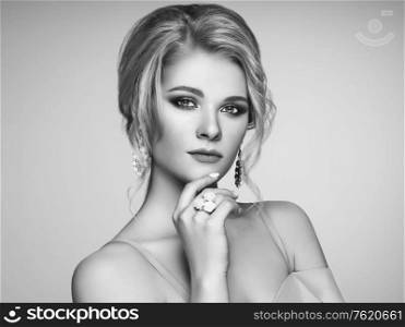 Portrait Beautiful Blonde Woman with Jewelry. Model Girl with Pearl Manicure on Nails. Elegant Hairstyle. Precious Stones and Silver. Beauty and Fashion Accessories. Perfect Make-Up. Black and White photo