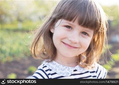 portrait Beautiful little girl in the garden