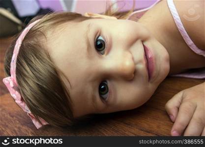 portrait beautiful little girl smiling in a studio