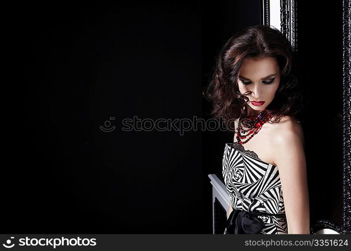 Portrait beautiful the girl with a make-up and a hairdress on a black background