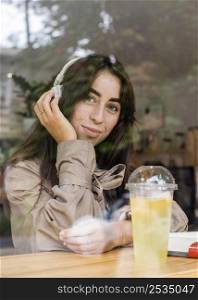 portrait beautiful woman cafe with fresh lemonade headphones
