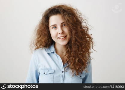 Portrait beautiful woman face close up portrait young curly hair studio on gray.. Portrait beautiful woman face close up portrait young curly hair studio on gray