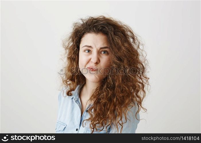 Portrait beautiful woman face close up portrait young curly hair studio on gray.. Portrait beautiful woman face close up portrait young curly hair studio on gray